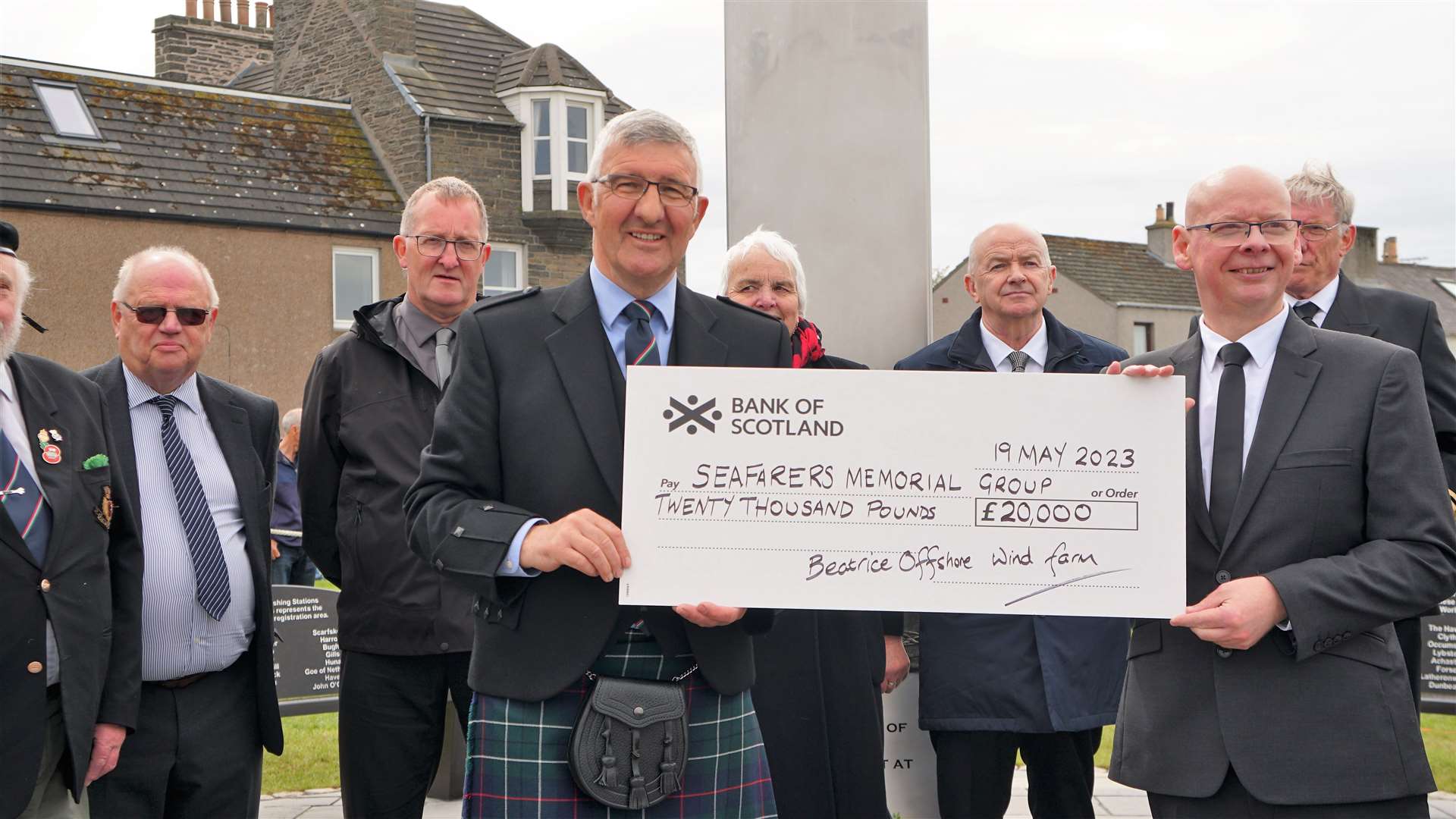 David Shearer (right), SSE Renewables community investment manager, presenting a £20,000 cheque from the Beatrice offshore wind farm to Willie Watt, with other Seafarers Memorial Group committee members looking on. Picture: DGS
