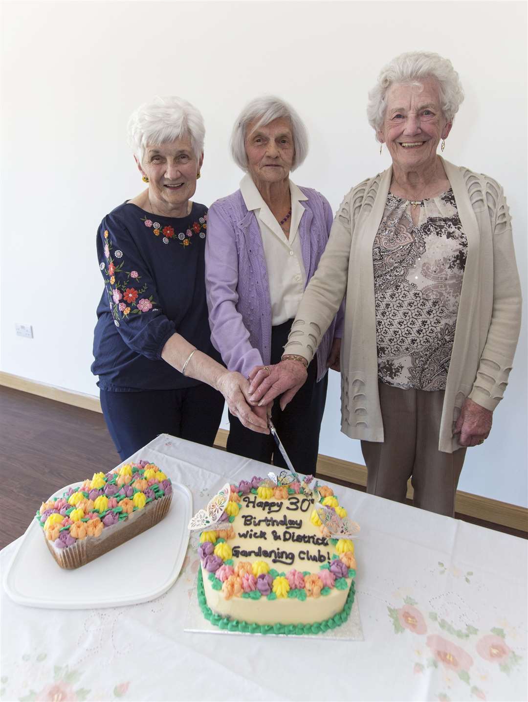 Wick and District Gardening Club's 30th anniversary cake is cut by club secretary Virginia Miller (centre) along with Betty Webster (left) and Bunty Oliphant. All three ladies were present at the club's inaugural meeting in 1993. Picture: Robert MacDonald / Northern Studios