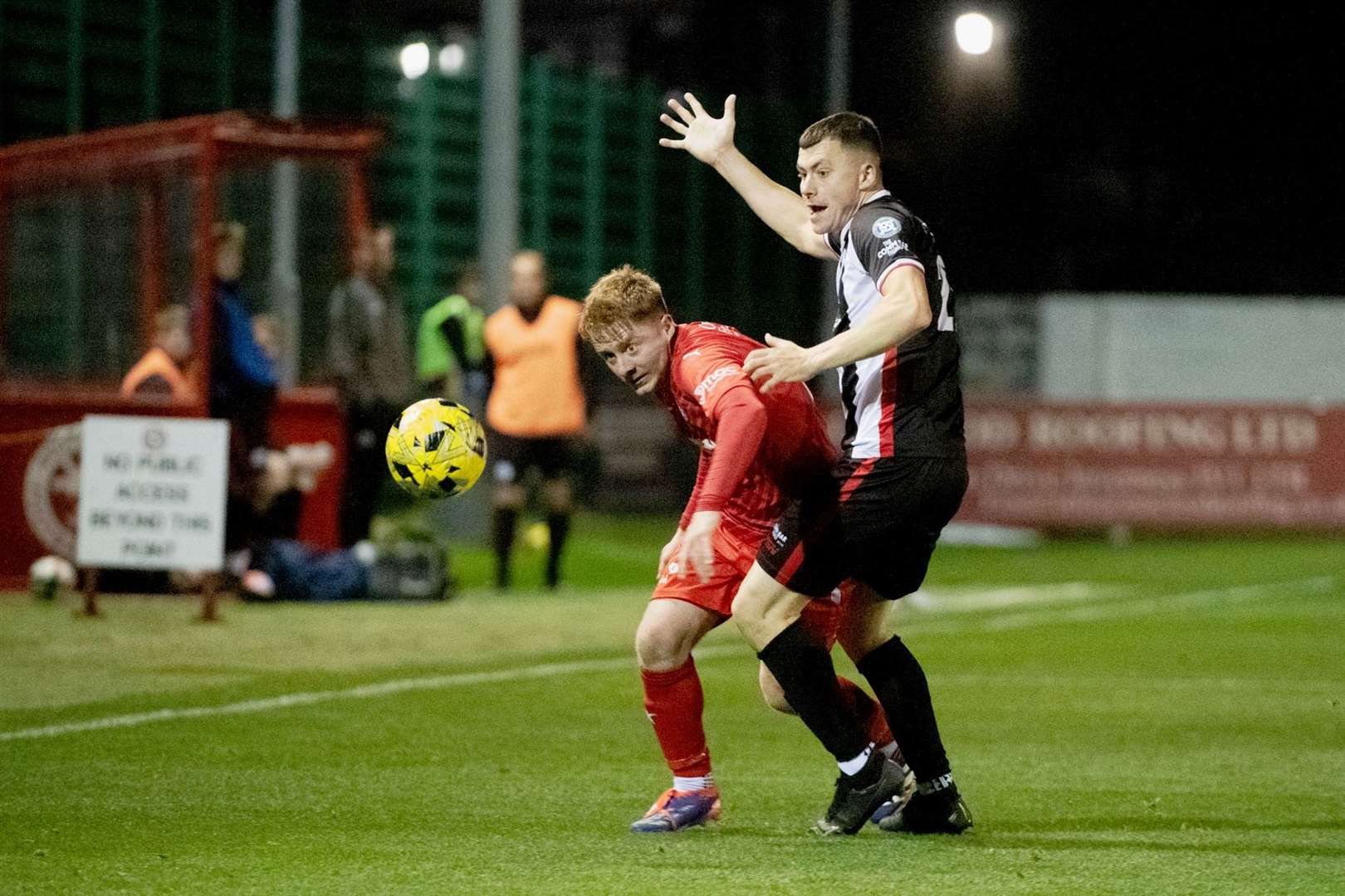 Brora's Andy Macrae and Wick Acaddmy's Ryan Campbell. Picture: Callum Mackay