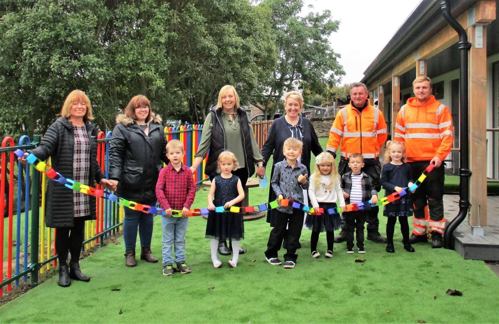 Early Learning Centre at Miller Academy official opening with, from left at rear, Susan Gerrard (parent council treasurer), Hayley Mackay (parent council chairperson), Liz MacKintosh (senior early years practitioner), Jacqui Budge (headteacher), Michael MacAllan and Logan Henderson (both from GMR Henderson). At front are some of the new settings learners who helped cut the specially made recycled rainbow ribbon to open their garden.