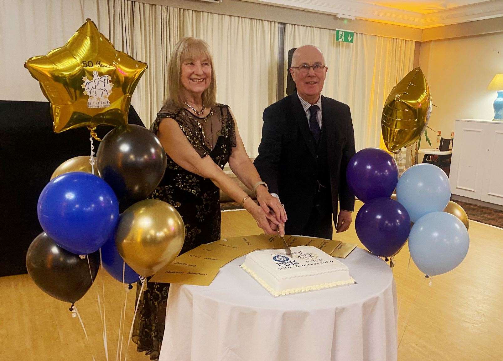 Pauline and George Coghill, Stemster, who were both on the first riding club committee, cutting the cake. George was the treasurer.