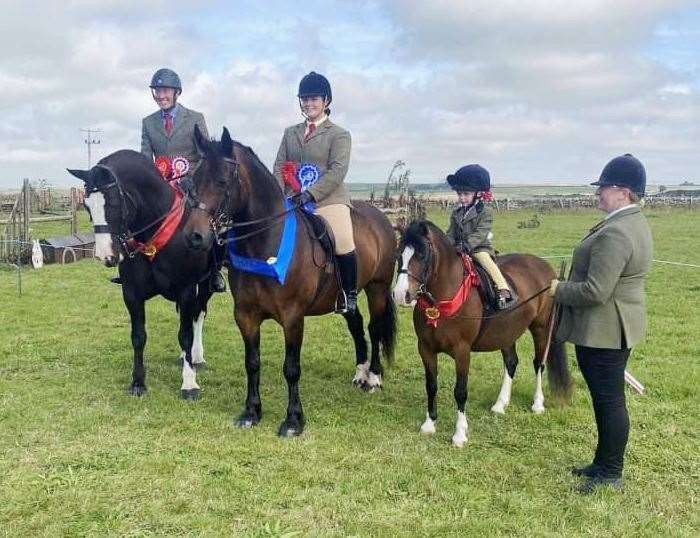 From left: Ridden horse champion Russell Skelton, Kira Fraser, reserve champion ridden pony, and Zara Manson with her mum Nicola and the champion ridden pony.