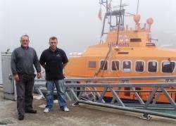 Bruce Tait and Gordie Morrison pictured yesterday with Wick lifeboat at its berth in the town’s harbour.