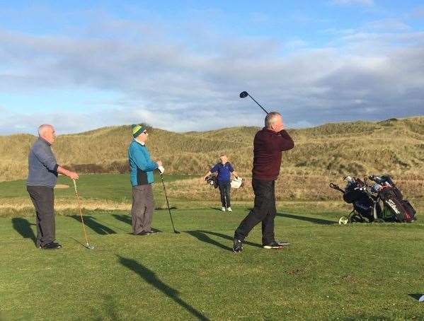 Leslie Malcolm teeing off at the seventh hole during Saturday's eclectic competition at Reay, while playing partners Grant Maxwell and Ian Farquhar look on.