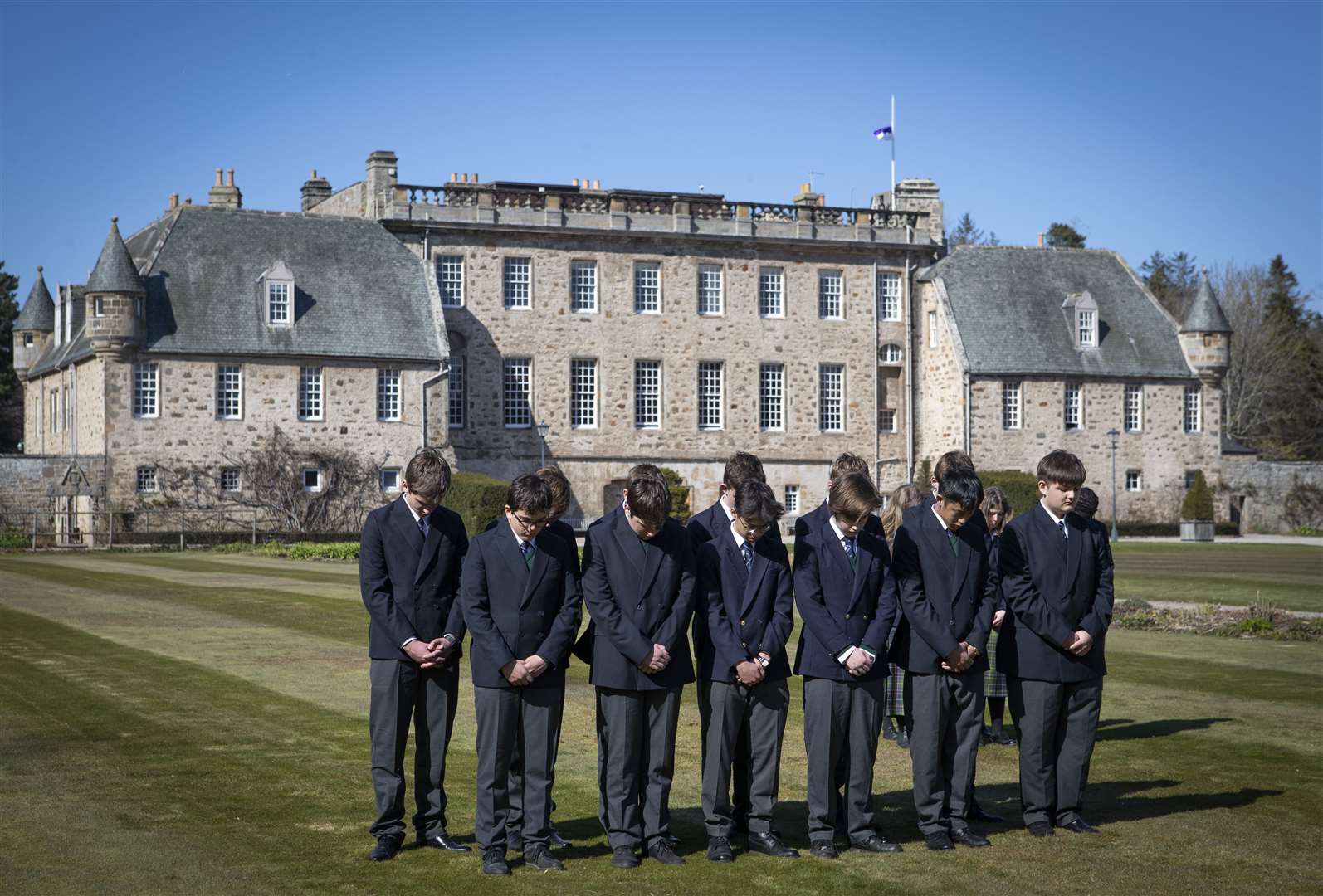 Pupils at the Duke of Edinburgh’s former school, Gordonstoun in Moray, observe the one-minute silence on the day of his funeral (Jane Barlow/PA)